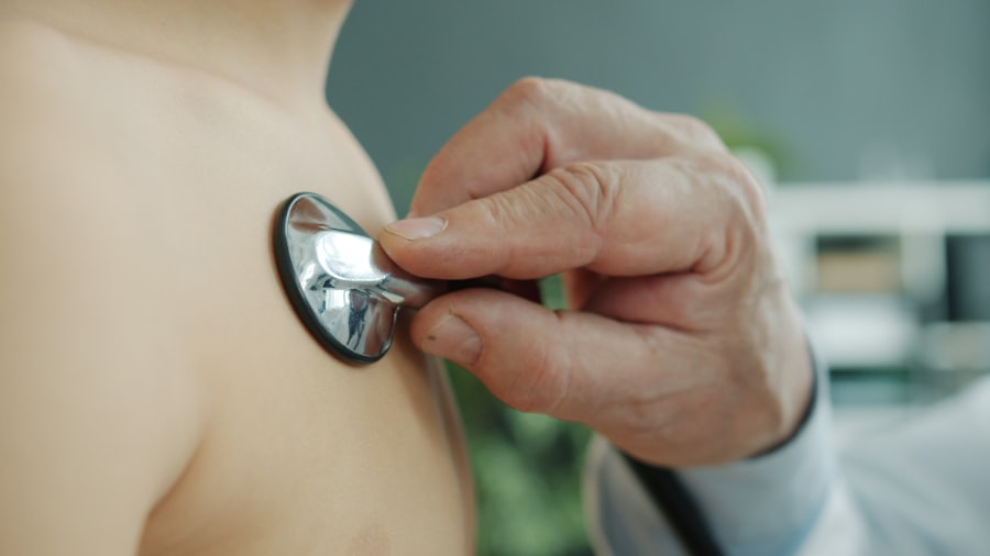 Doctor using a stethoscope to check a patient's heart during a preventive exam